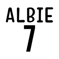 Black flat artwork showing a rounded name 'ALBIE' over a big number 7, birthday age iron-on design