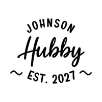 Flat black design: curved 'JOHNSON' above script 'Hubby', 'EST. 2027' framed by wavy lines