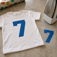 Birthday Age Number iron-on transfer: blue number 7 on a white kids T-shirt, with the matching transfer beside it