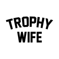 Flat black artwork on white: 'TROPHY WIFE' in arched varsity letters, iron-on transfer design