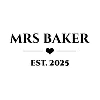 Flat serif artwork in black: 'MRS BAKER' above a heart divider and 'EST. 2025', personalised wedding iron-on transfer