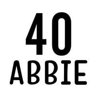 Flat black artwork on white: large '40' above 'ABBIE' in rounded capitals, name and age iron-on transfer design