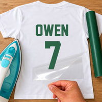 5-a-Side Football Name Number iron-on transfer: green OWEN 7 on a white T-shirt, film being peeled