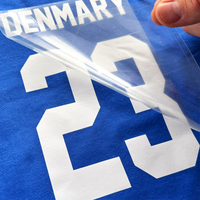 Mechanic Name iron-on, sample finish: white DENMARY 23 name and number vinyl peeled from its film on a blue shirt