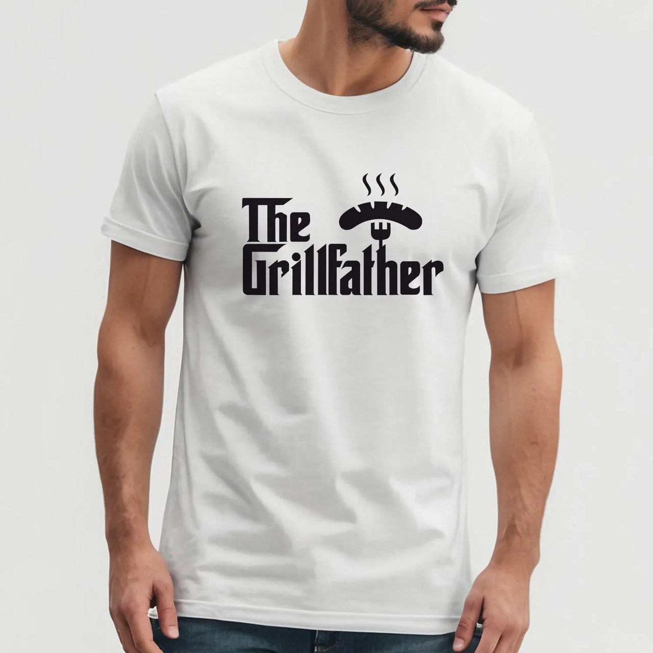 BBQ Enthusiast T-Shirt with "Grillfather" motif for barbecue masters. White shirt worn by man. Ideal for BBQ parties, durable and comfortable.