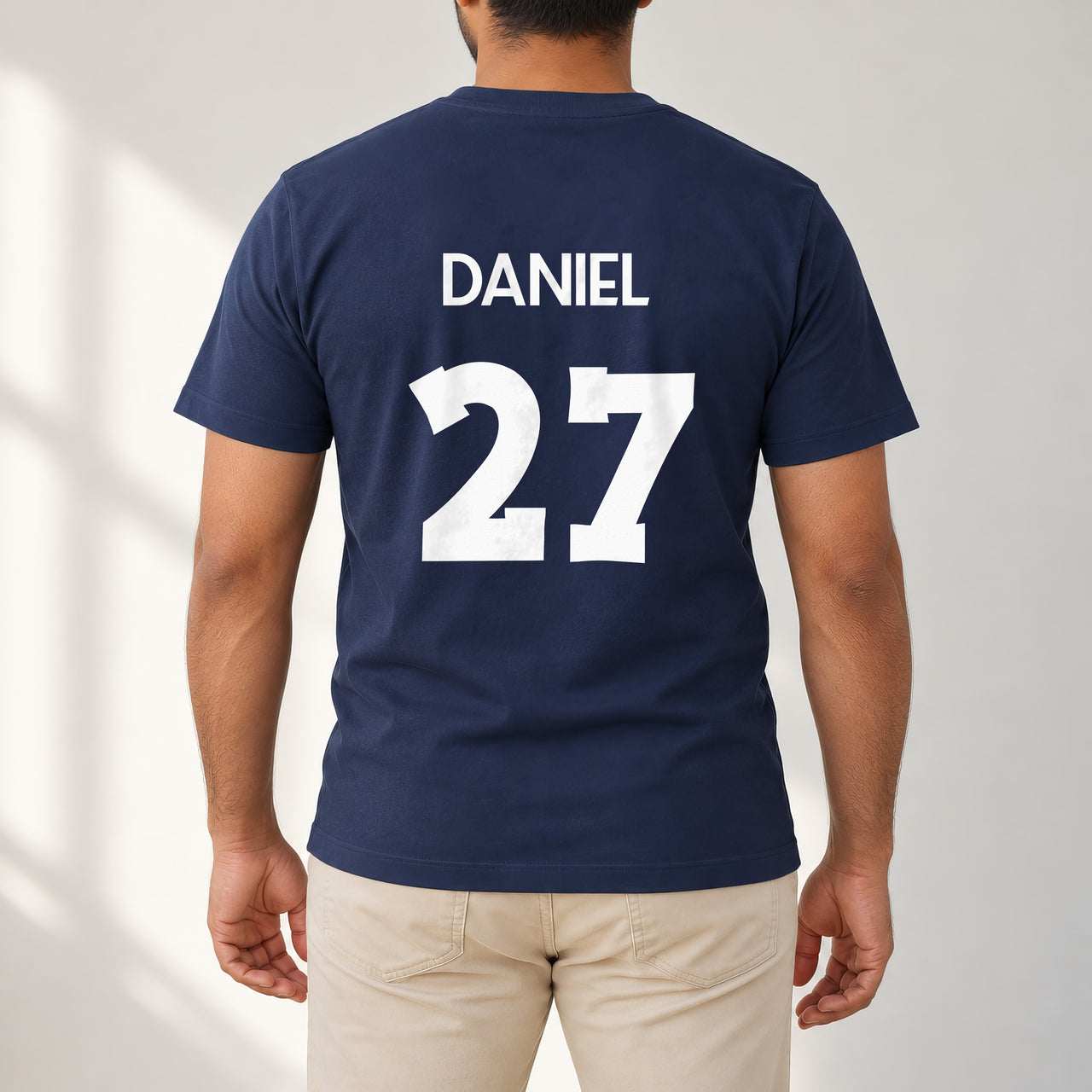 Adult Football Shirt Name Number Iron-On Transfer, shown on a navy t-shirt (back view)