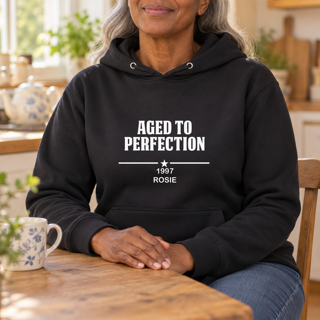 Aged To Perfection Iron-On Transfer, shown on a black hoodie