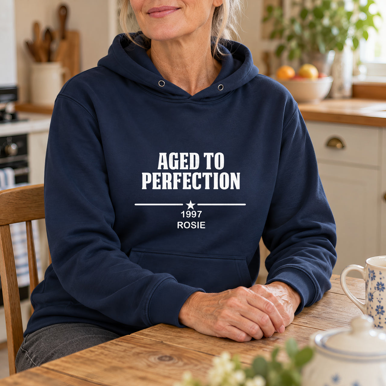 Aged To Perfection Iron-On Transfer, shown on a navy hoodie