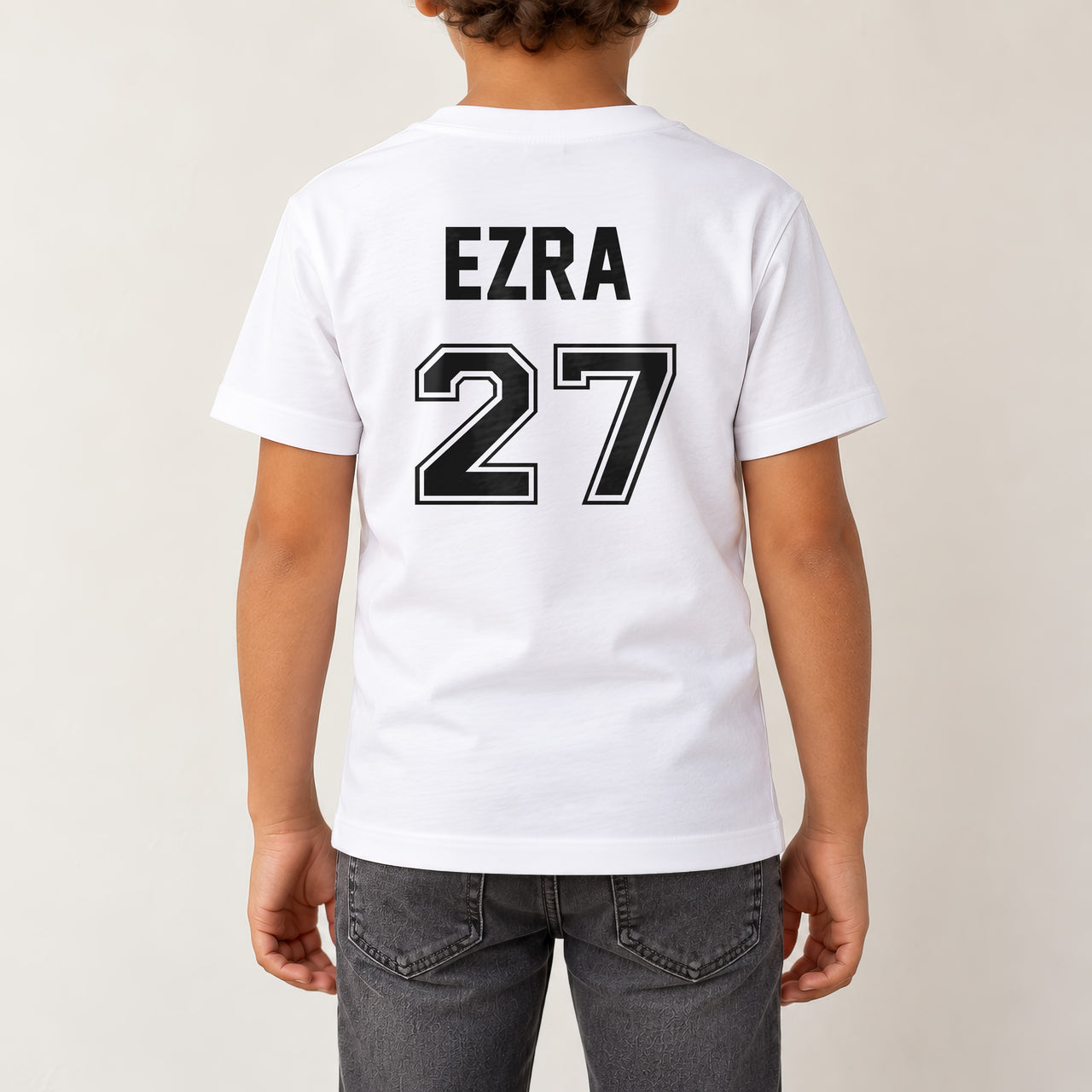 Baby Football Kit Name Number Iron-On Transfer, shown on a white kids t-shirt (back view)