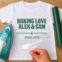 Baking Love iron-on transfer: green BAKING LOVE ALEX & SAM with a star and SINCE 2018 on a white T-shirt, film being peeled