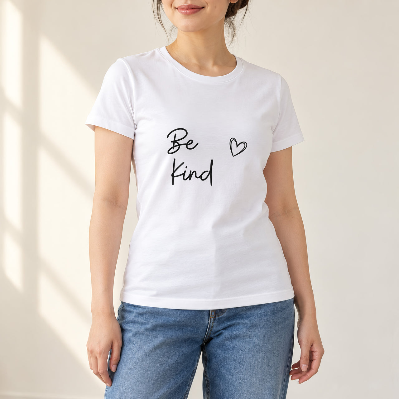 White T-shirt with the Be Kind Script Heart design printed on the chest