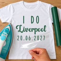 White T-shirt with green 'I DO', 'Liverpool' and '20.06.2027' lettering, personalised hen party HTV transfer being peeled
