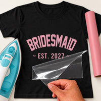 Black T-shirt with pink arched varsity 'BRIDESMAID' and '~ EST. 2027 ~', bridesmaid iron-on transfer
