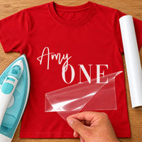 Cake Smash First Birthday iron-on transfer: white Amy ONE on a red T-shirt, film being peeled