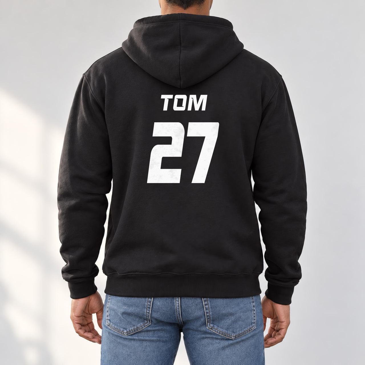 Black hoodie with the Charity Match Name and Number design printed on the back