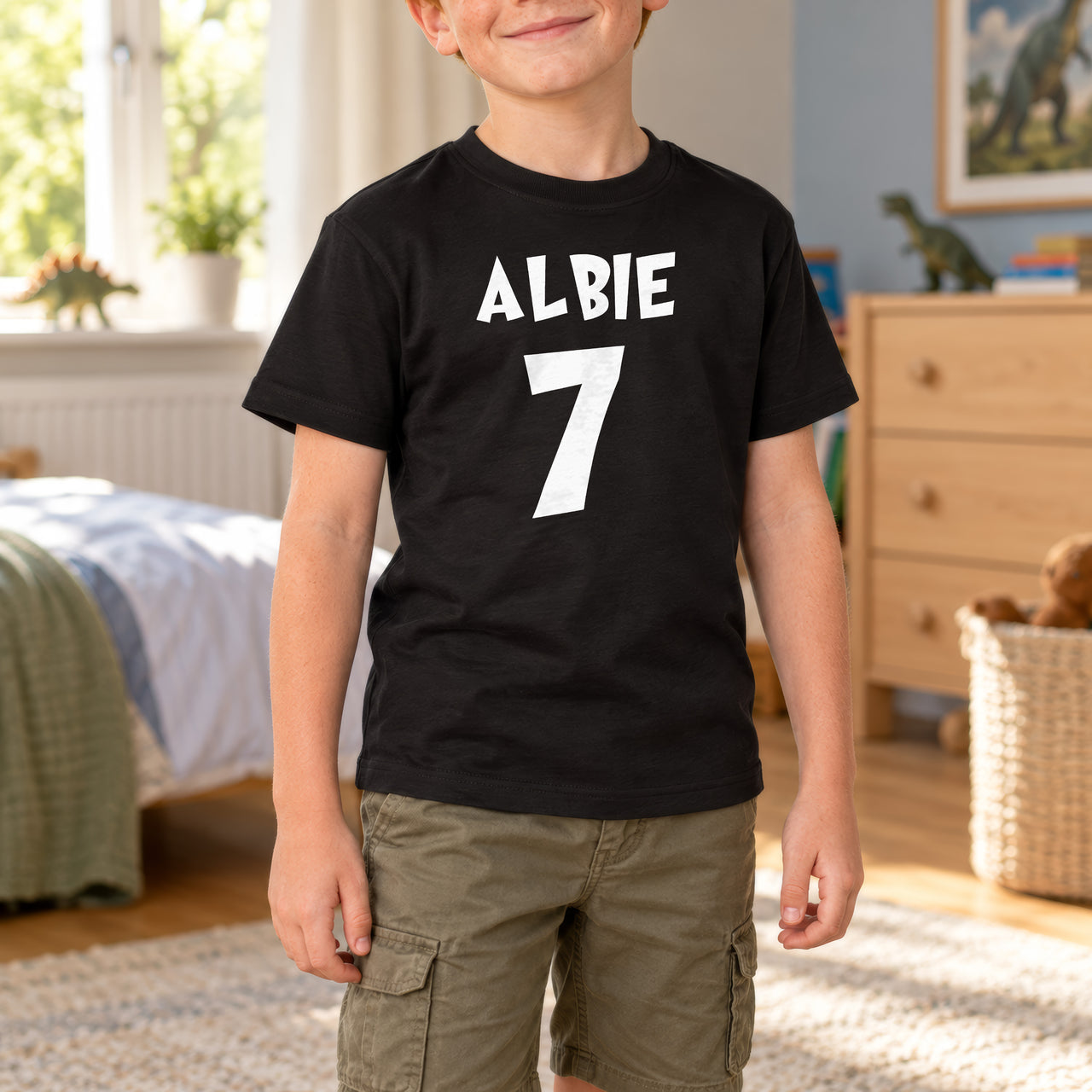 Child's Birthday Name Iron-On Transfer, shown on a black kids t-shirt