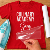 Executive Chef iron-on transfer: white CULINARY ACADEMY Sam EXECUTIVE CHEF on a red T-shirt, film being peeled