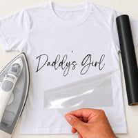 Daddy's Girl iron-on transfer: black Daddy's Girl script on a white T-shirt, film being peeled