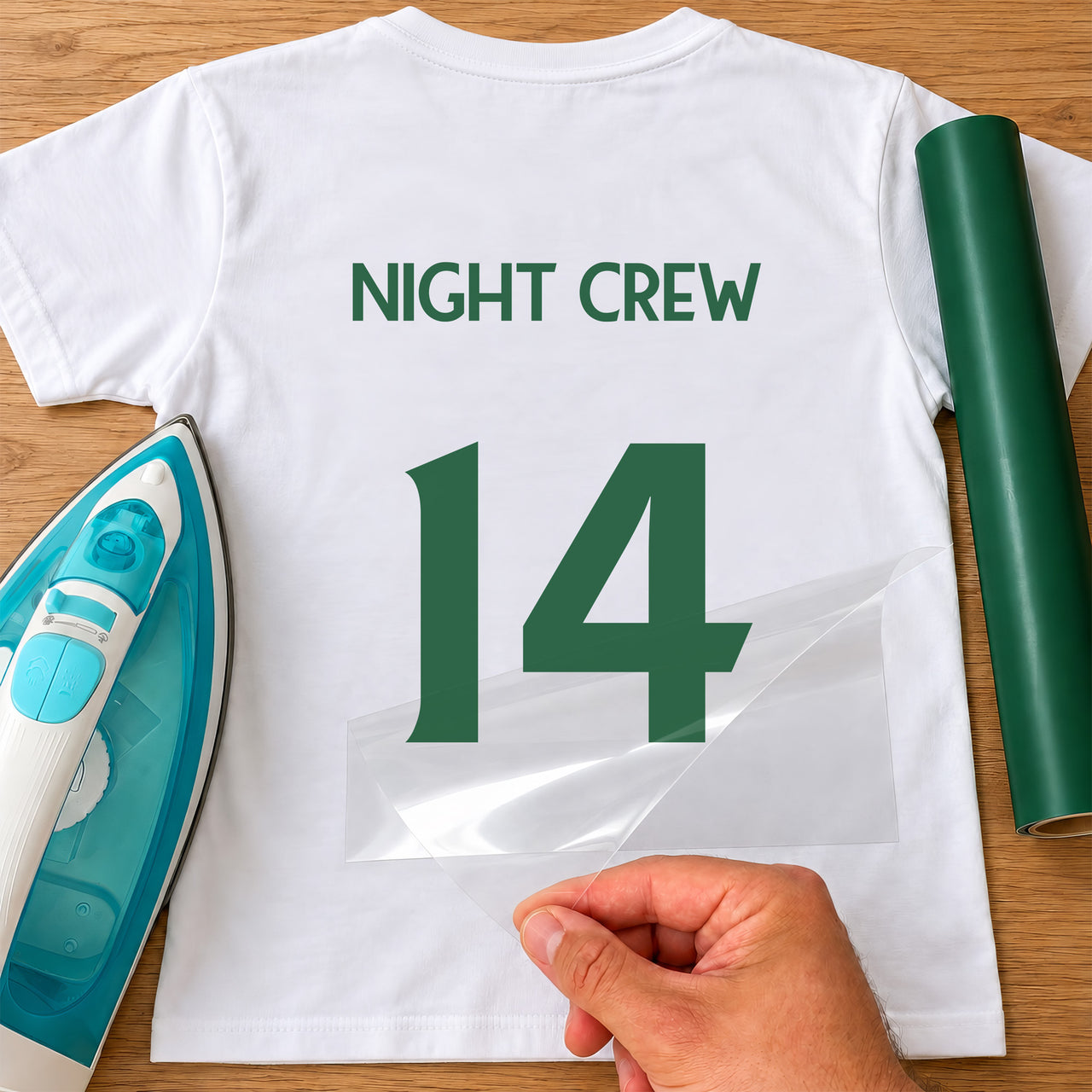 Esports Clan Tag & Number iron-on transfer: green NIGHT CREW 14 on a white T-shirt, film being peeled