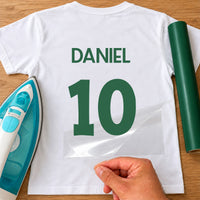 Family Fun Match Name Number iron-on transfer: green DANIEL 10 on a white T-shirt, film being peeled