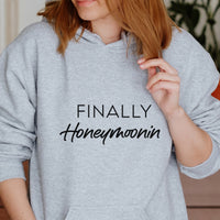 Finally Honeymoonin Iron-On Transfer - Newlywed Travel Design shown on a hoodie