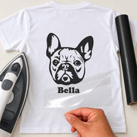 White T-shirt with black French Bulldog face iron-on transfer and name 'Bella', iron and black vinyl roll