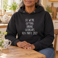 Getting Drunk Hen Do Iron-On Transfer, shown on a black hoodie