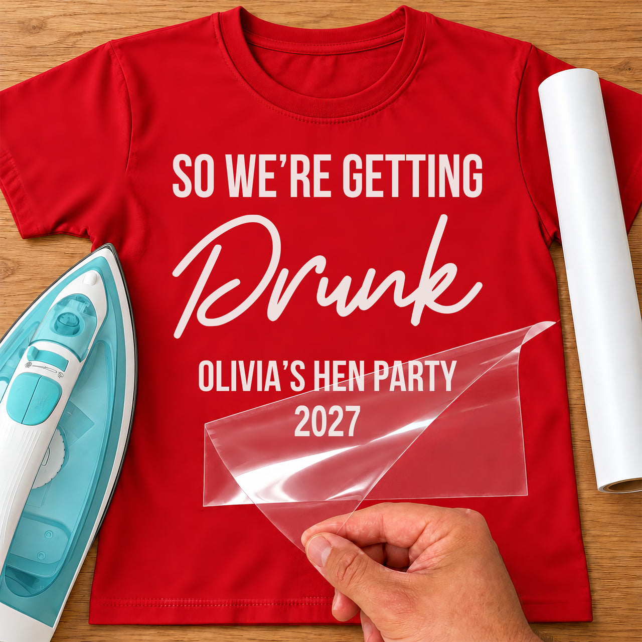 Red tee mockup with white vinyl 'So we're getting Drunk' and 'Olivia's Hen Party 2027' for a hen do