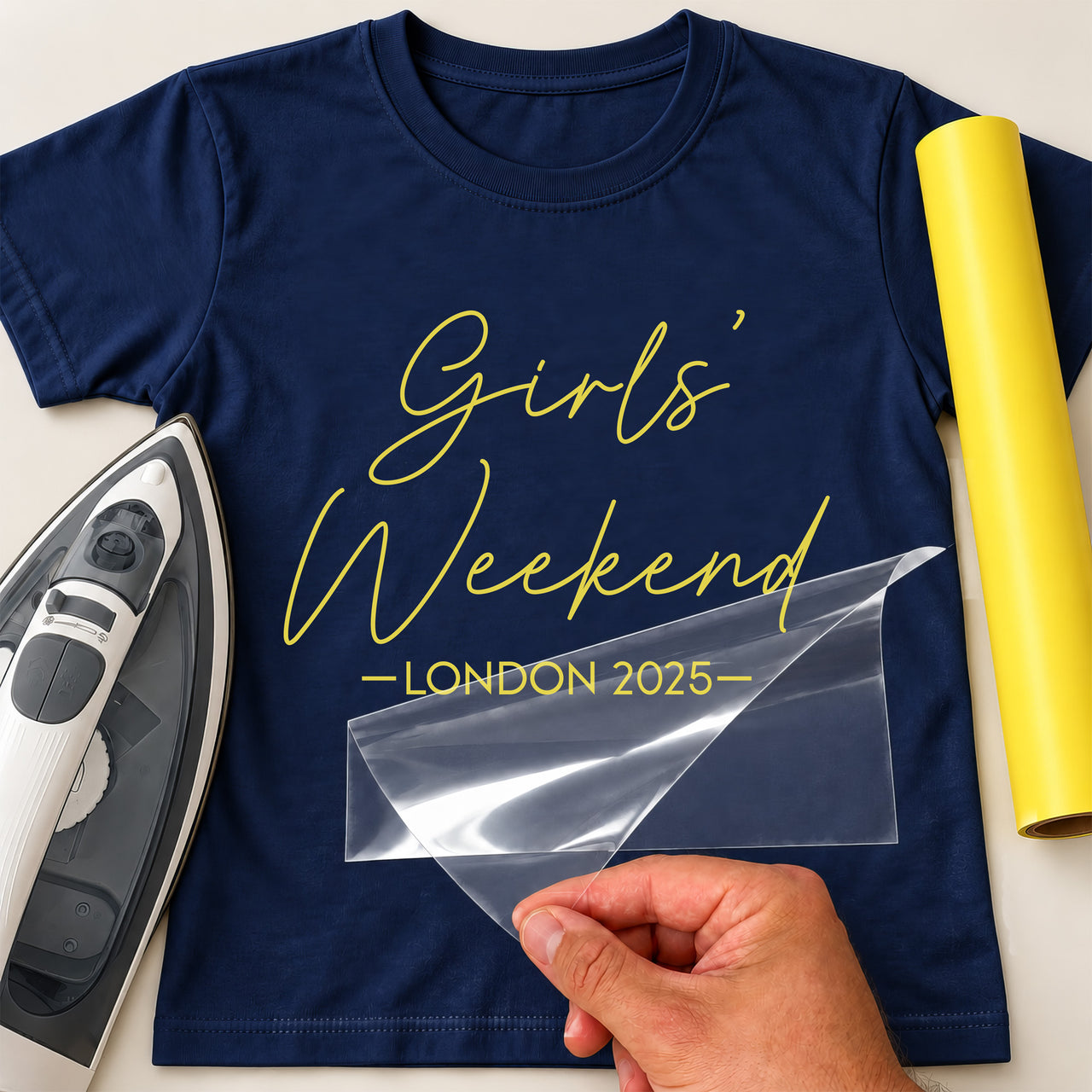 Navy T-shirt with yellow script 'Girls' Weekend' and 'LONDON 2025' iron-on transfer, iron and yellow vinyl roll