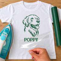 White T-shirt with green retriever head line drawing and 'POPPY' name iron-on transfer, iron and green vinyl roll