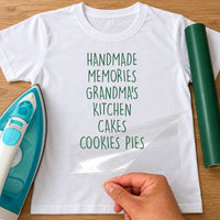 White T-shirt with 'HANDMADE MEMORIES GRANDMA'S KITCHEN CAKES COOKIES PIES' in green, iron-on vinyl transfer