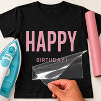 Pink heat transfer vinyl on a black T-shirt mockup, large 'HAPPY' over small 'BIRTHDAY!', iron and pink vinyl roll