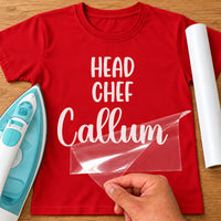Head Chef name iron-on transfer: white HEAD CHEF Callum on a red T-shirt, film being peeled