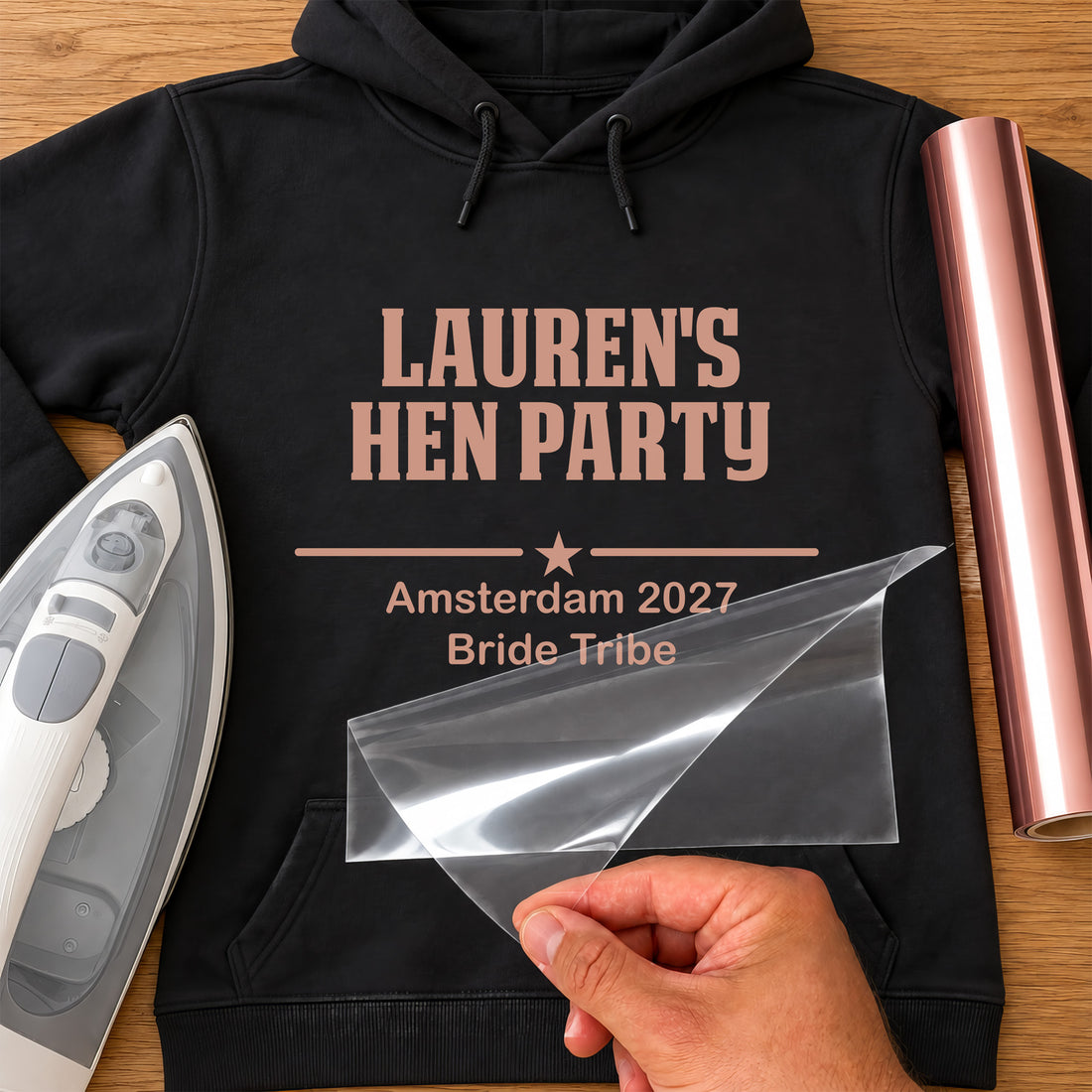 Black hoodie with rose gold vinyl 'LAUREN'S HEN PARTY', 'Amsterdam 2027 Bride Tribe', iron-on vinyl transfer