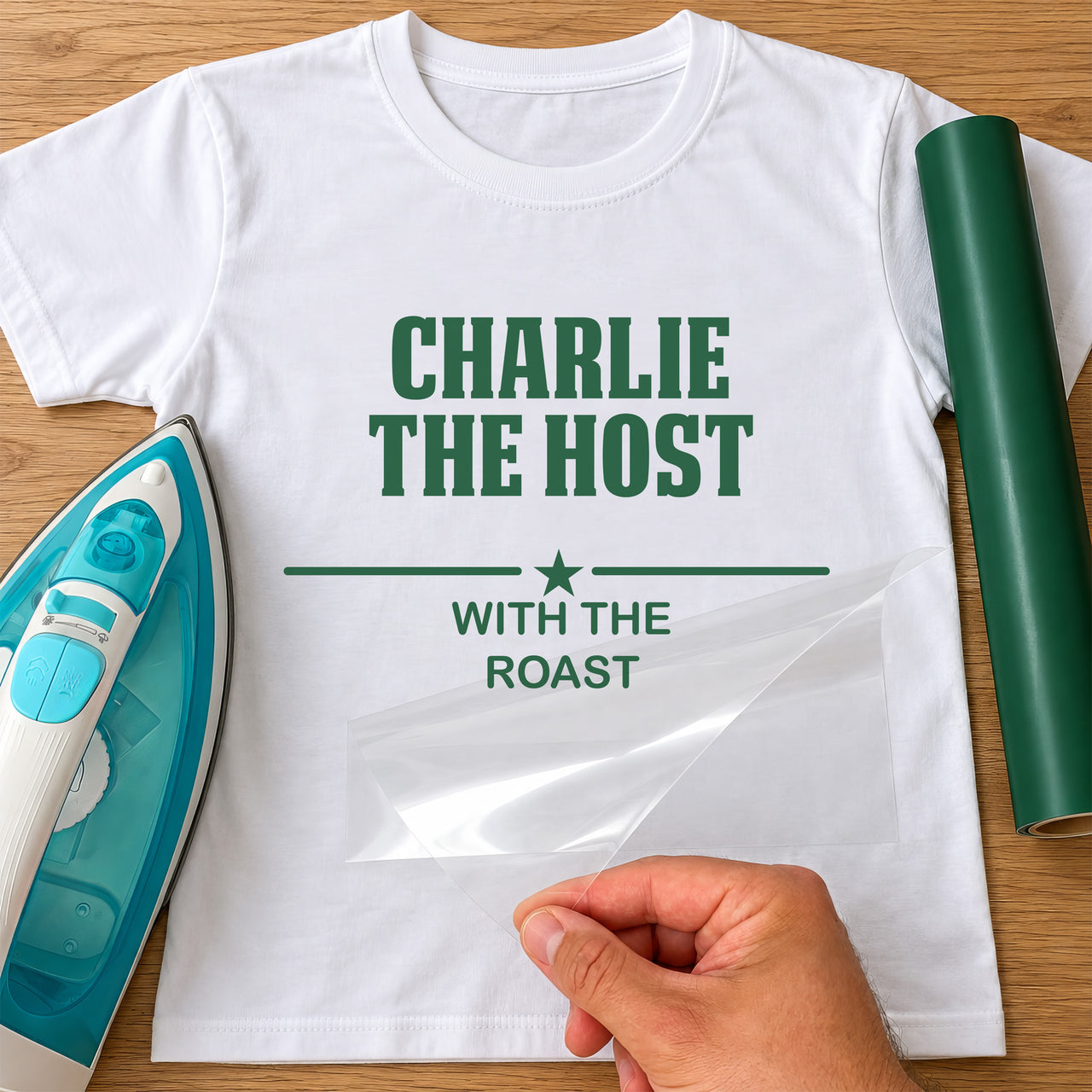 Host With The Roast iron-on transfer: green CHARLIE THE HOST WITH THE ROAST with a star on a white T-shirt, film being peeled