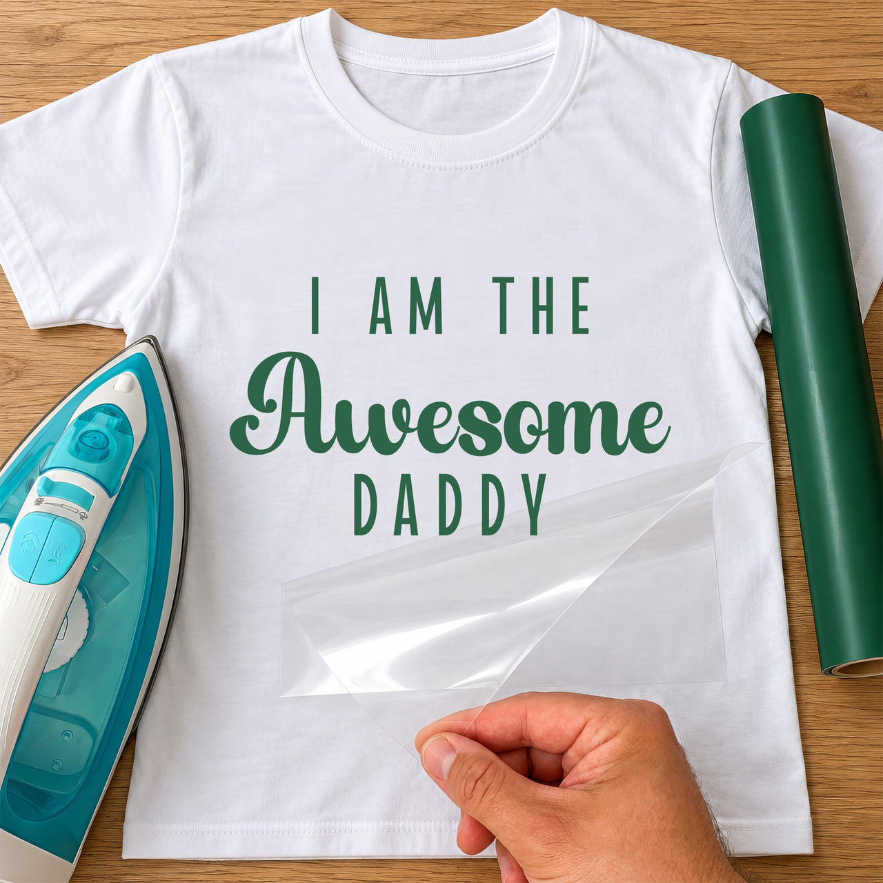White T-shirt with green 'I AM THE Awesome DADDY' iron-on transfer, iron and green vinyl roll
