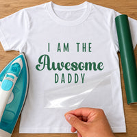 White T-shirt with green 'I AM THE Awesome DADDY' iron-on transfer, iron and green vinyl roll