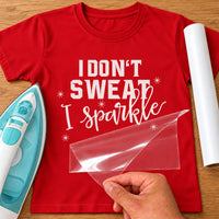 I Don't Sweat I Sparkle iron-on transfer: white slogan with sparkles on a red T-shirt, film being peeled