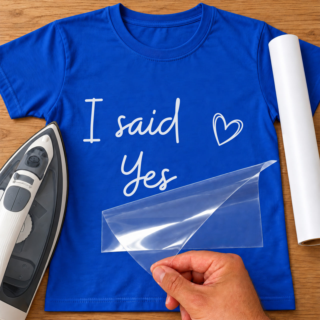 Blue T-shirt mockup with white handwritten 'I said Yes' and an outline heart in heat transfer vinyl