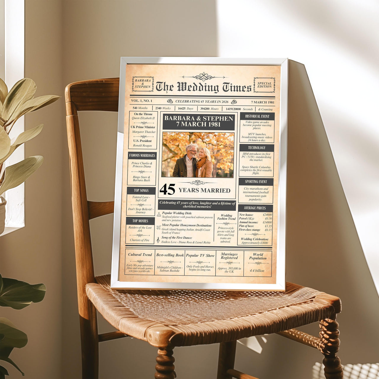 Framed 45th anniversary newspaper print on a wooden wicker chair in sunlight, showing a couple photo and names