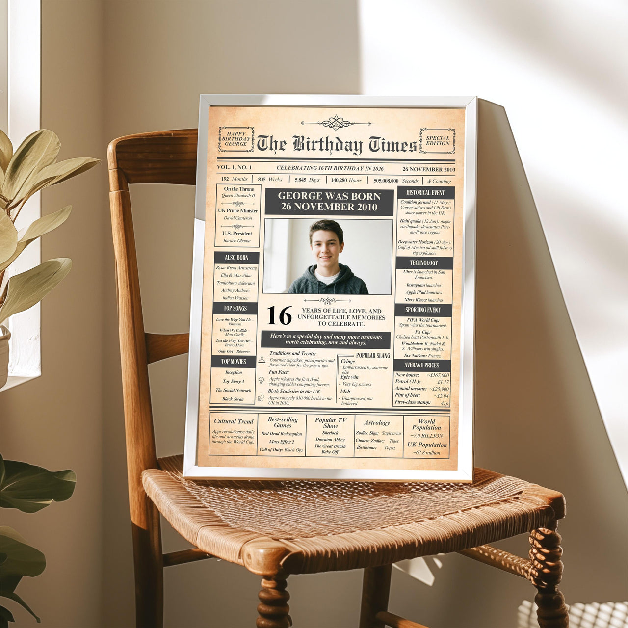Personalised 16th birthday front page print in a silver frame on a wooden chair by a sunny window