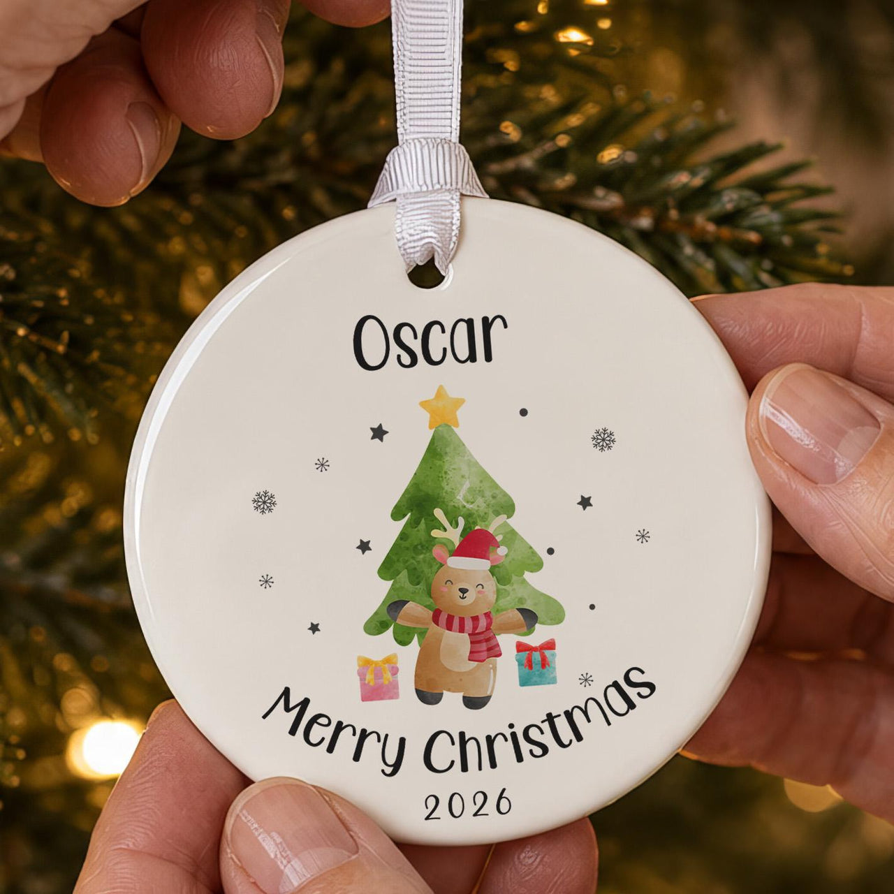 Reindeer ceramic bauble: cartoon reindeer in a Santa hat before a green tree with gifts, Oscar, Merry Christmas 2026
