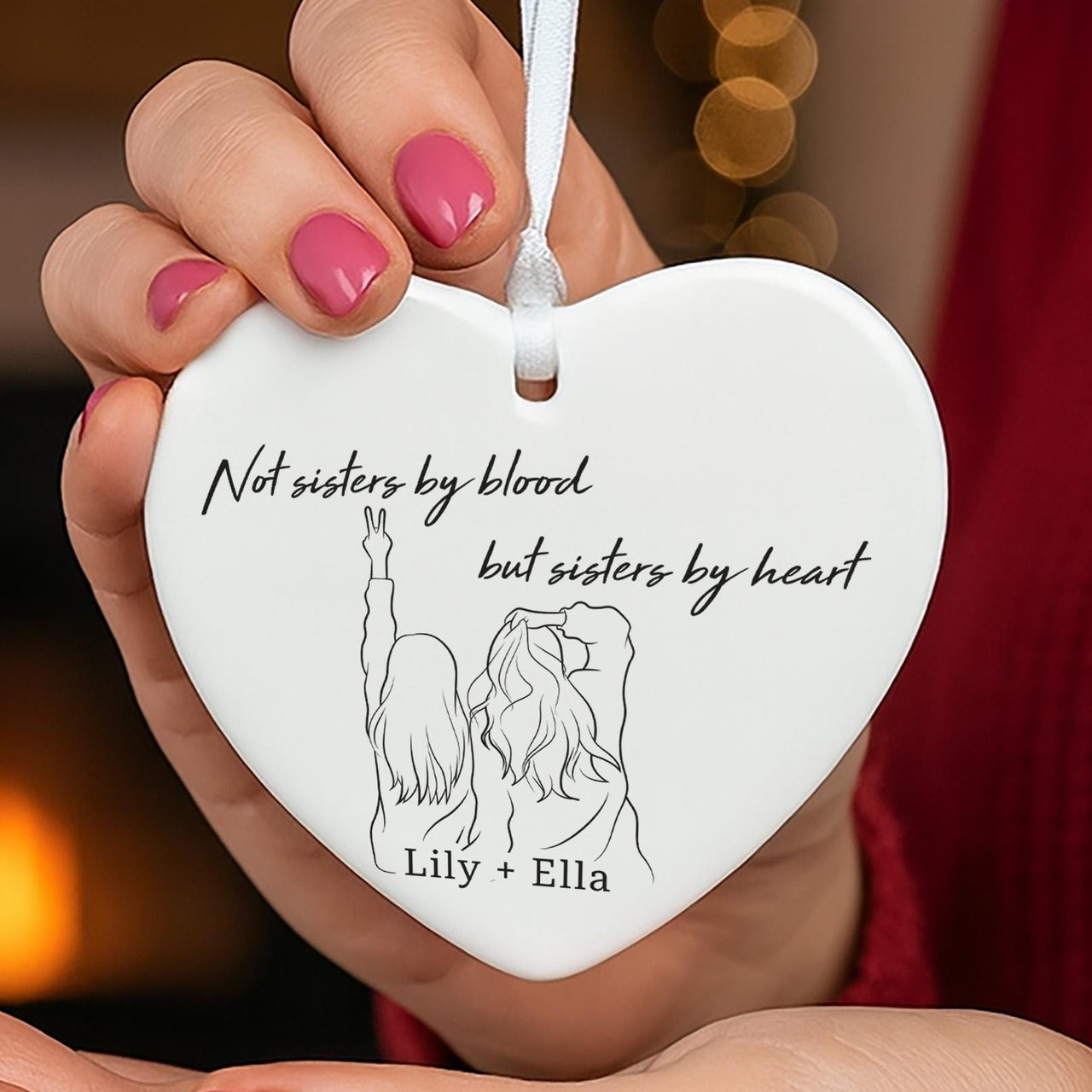 Sisters by heart ceramic ornament: white heart with a line drawing of two girls, sisters by heart verse, Lily + Ella