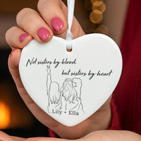 Sisters by heart ceramic ornament: white heart with a line drawing of two girls, sisters by heart verse, Lily + Ella