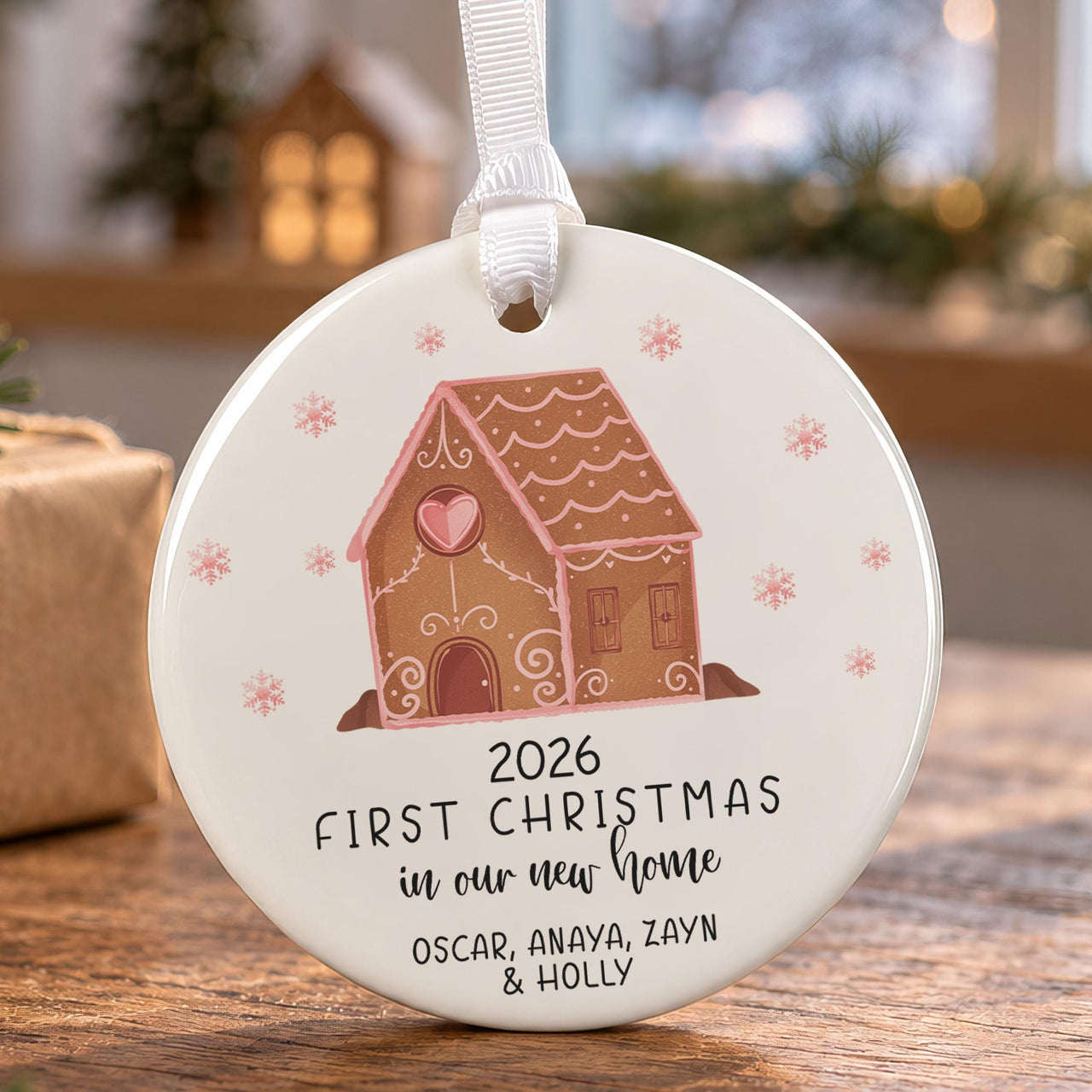 New home ceramic bauble: gingerbread house with a pink heart and snowflakes, First Christmas 2026, four family names