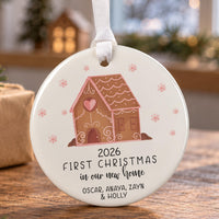 New home ceramic bauble: gingerbread house with a pink heart and snowflakes, First Christmas 2026, four family names