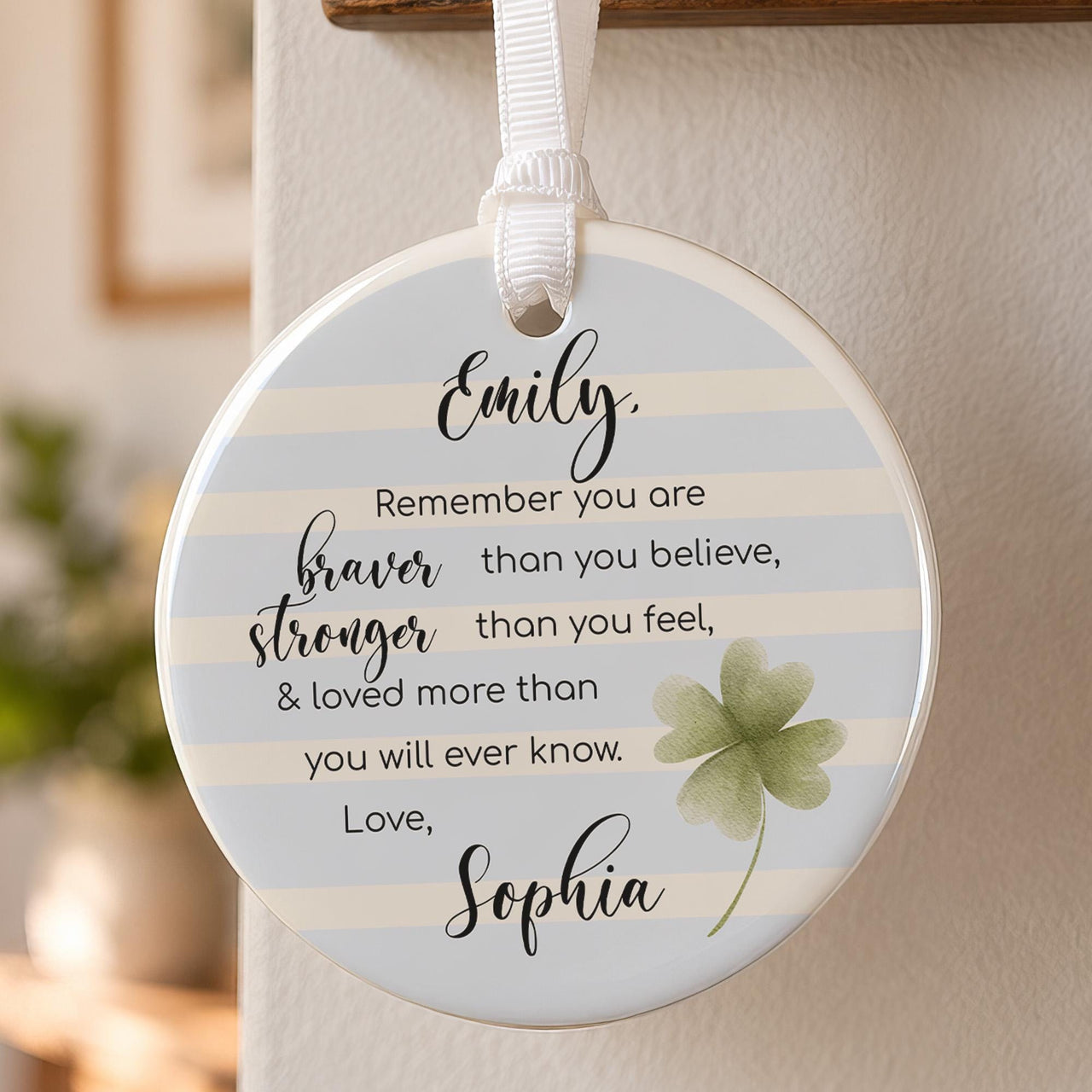 Braver than you believe ceramic ornament: round bauble with blue stripes, a green clover, the verse, Emily and Sophia