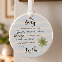 Braver than you believe ceramic ornament: round bauble with blue stripes, a green clover, the verse, Emily and Sophia