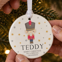 Nutcracker ceramic bauble: toy soldier in a red jacket among gold stars, Teddy, Merry Christmas to a Special Grandson