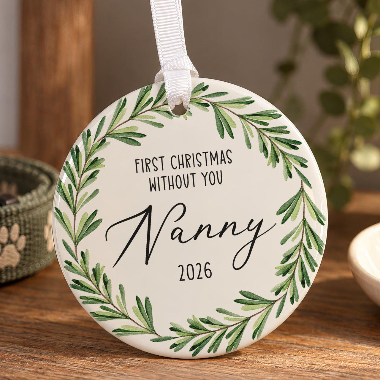 Memorial Christmas ornament: ceramic disc with a green leaf wreath, First Christmas Without You and Nanny 2026